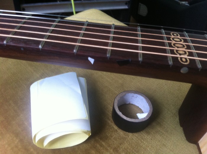 Using white sticky paper and black tape to temporarily "correct' the 10th fret marker
